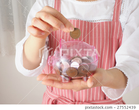 A woman with a piggy bank and coins 27552439