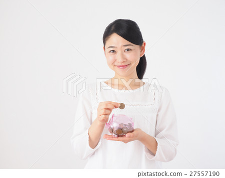 A woman with a piggy bank and coin A woman with a piggy bank and coin 27557190