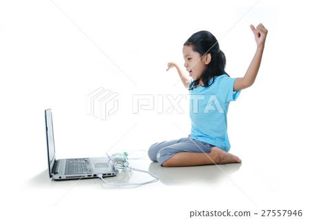 Asian little girl playing games with laptop Asian little girl playing games with laptop 27557946