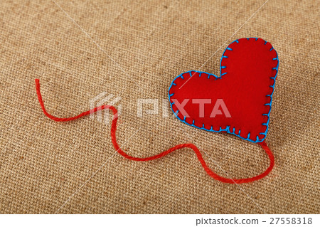 Red felt craft heart over canvas close up Red felt craft heart over canvas close up 27558318