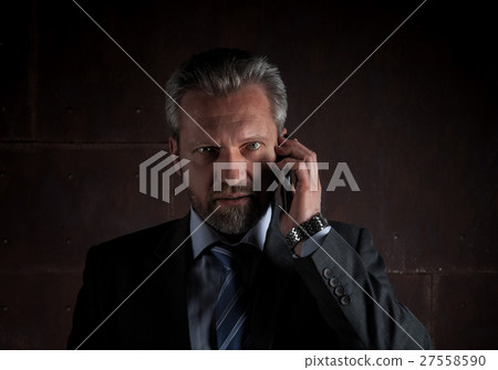 Portrait of a mature businessman on black Portrait of a mature businessman on black 27558590