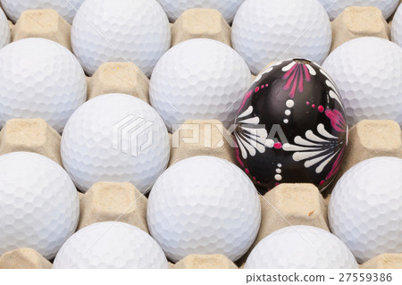 Golf balls in the box for eggs and Easter egg Golf balls in the box for eggs and Easter egg 27559386