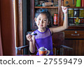 Happy asian girl eating chocolate ice cream. 27559479