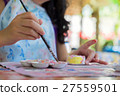 Little hands of kid painting on the plaster statue 27559501
