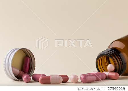 Bottle of pills from the brown glass and colorful Bottle of pills from the brown glass and colorful 27560019