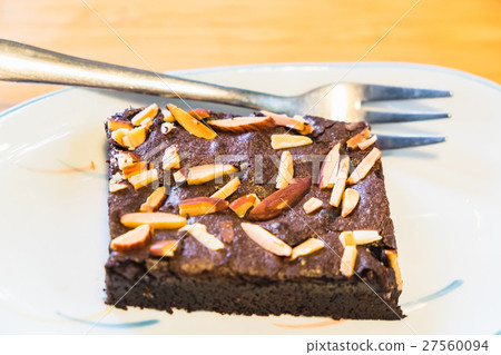 almond chocolate brownie on white dish and fork 27560094