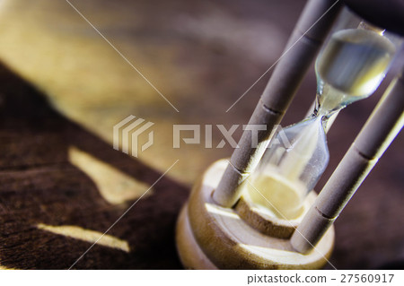 Closeup hourglass on black background Closeup hourglass on black background 27560917
