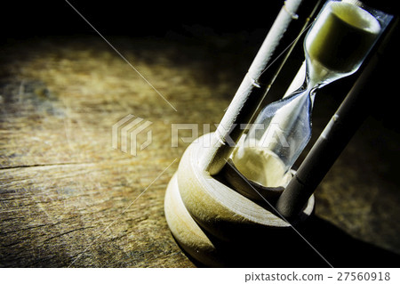 Closeup hourglass on black background Closeup hourglass on black background 27560918