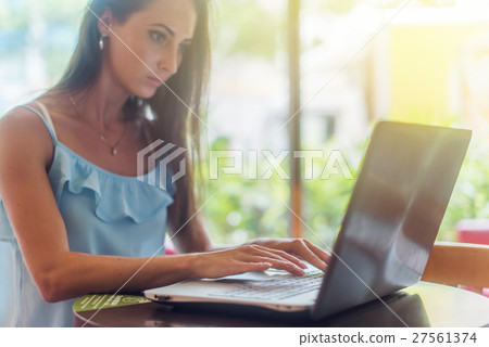 Young business woman working on her laptop, typing Young business woman working on her laptop, typing 27561374