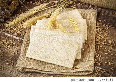 Crispbread with grains and ears on wooden table  27561915