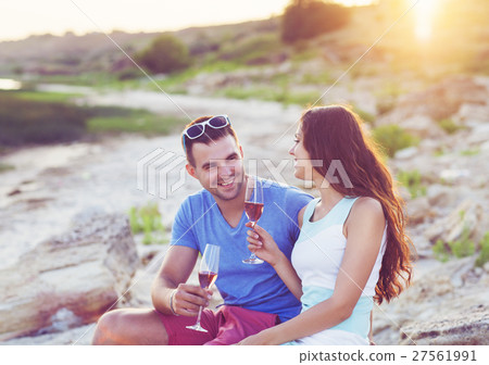 Happy couple toasting champagne at a relax party Happy couple toasting champagne at a relax party 27561991