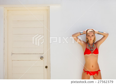 Sexy fashionable woman posing in a red bikini Sexy fashionable woman posing in a red bikini 27562379