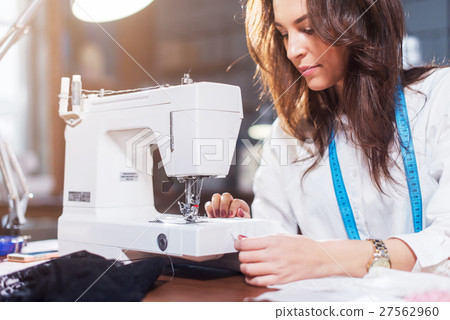 Young female fashion designer working on sewing 27562960