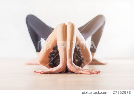 Woman doing yoga lying on floor in artistic 27562978