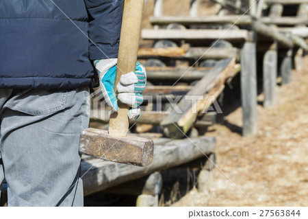 Worker with sledgehammer near to the broken wooden Worker with sledgehammer near to the broken wooden 27563844