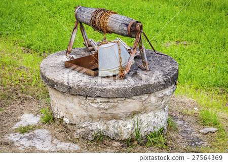 Old water well with bucket  27564369
