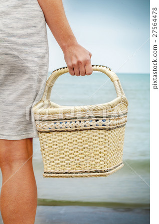 Woman with basket near sea Woman with basket near sea 27564478