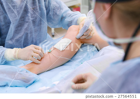 doctor and an assistant in operating room doctor and an assistant in operating room 27564551