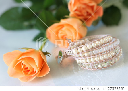 Table photo of roses and handmade bracelets 27572561