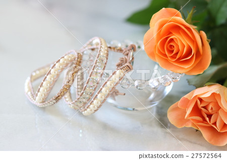 Table photo of roses and handmade bracelets 27572564