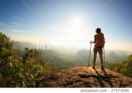 young travele onmountain peak observing locality 27573690