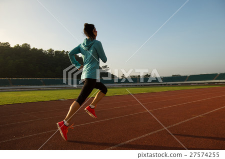 图库照片 young woman runner running on stadium track