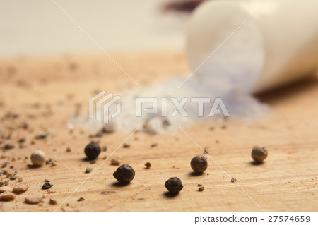 Pepper and salt on a kitchen wooden board Pepper and salt on a kitchen wooden board 27574659