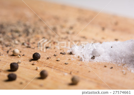 Pepper and salt on a kitchen wooden board. Pepper and salt on a kitchen wooden board. 27574661
