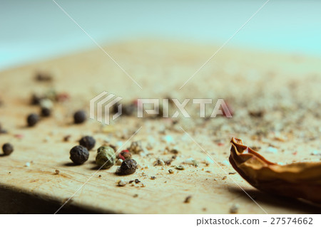 On a wooden board, ground pepper and peas 27574662