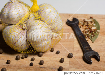 Spices on a cutting board and man's tools 27574679