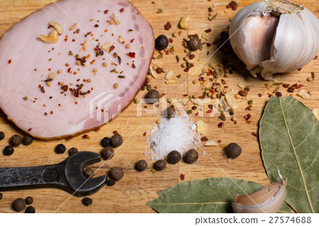 Spices on chopping board, bacon and a wrench Spices on chopping board, bacon and a wrench 27574688