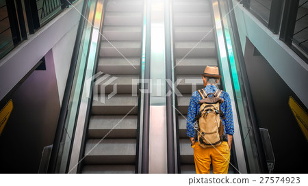 the unidentified tourist going up escalator the unidentified tourist going up escalator 27574923