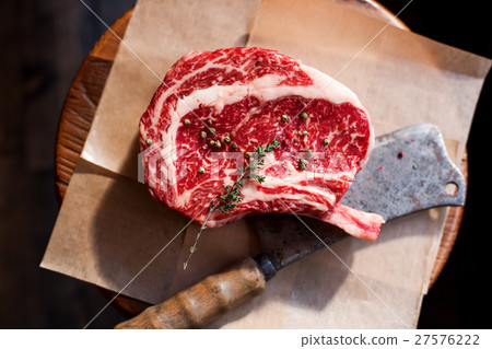 Bone In Rib Eye row Steak on pieces of salt Bone In Rib Eye row Steak on pieces of salt 27576222