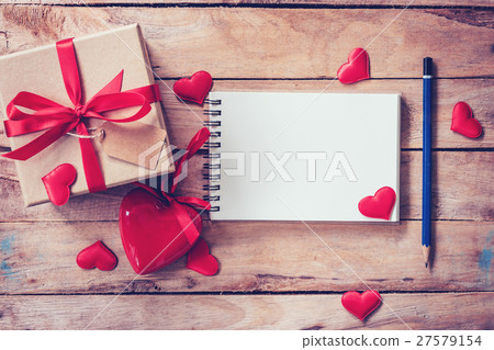 Blank notebook and gift box with red heart on wood Blank notebook and gift box with red heart on wood 27579154