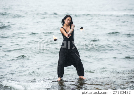 fire show on the shore of the sea 27583482