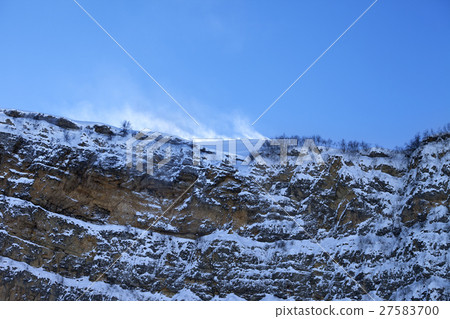 Rocks in snow at wind winter evening 27583700