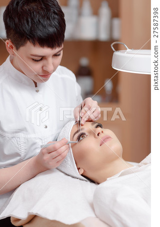 Professional stylist making eyelash extension for Professional stylist making eyelash extension for 27587398