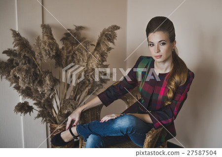 Girl in a wicker chair in the Studio 4849. 27587504