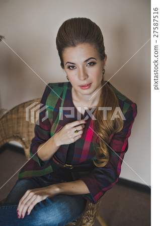 Girl sitting in a wicker chair 4851. 27587516