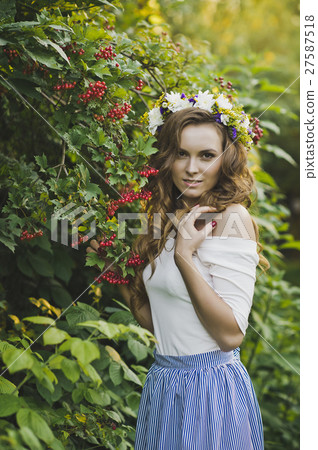 Girl with a wreath of flowers from a Bush of mountain ash 4789. 27587518