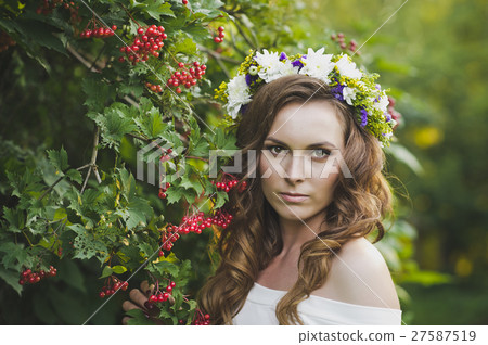 Girl with a wreath of flowers from a Bush of mountain ash 4790. 27587519