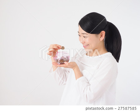 A woman with a piggy bank and coin 27587585