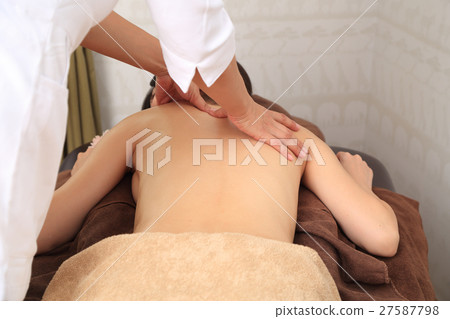 The back of a woman who receives an esthetic The back of a woman who receives an esthetic 27587798