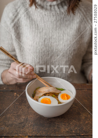 Woman eating Asian soup Ramen with chicken Woman eating Asian soup Ramen with chicken 27588029