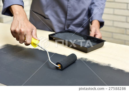 young man painting a wooden board 27588286