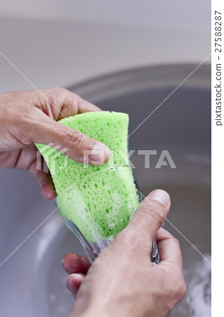 young man washing a glass young man washing a glass 27588287