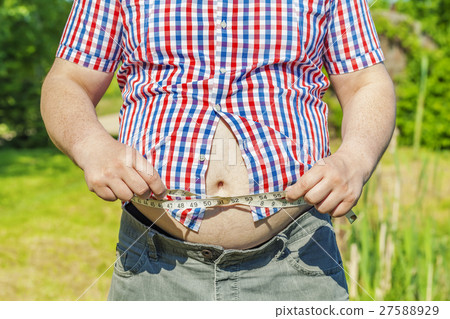 Fat man with measure tape at outdoor 27588929