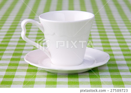 Empty cup on the checkered tablecloth Empty cup on the checkered tablecloth 27589723