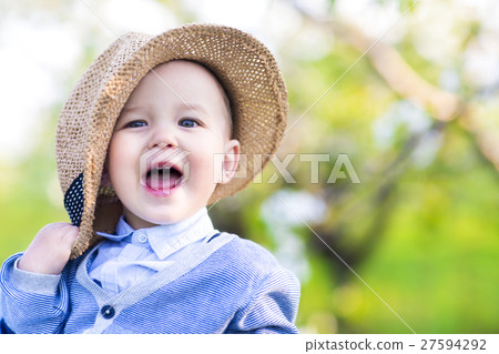 Cute happy caucasian baby boy in spring park looks Cute happy caucasian baby boy in spring park looks 27594292