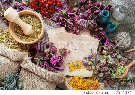 Healing herbs in hessian bags, mortar and bottles Healing herbs in hessian bags, mortar and bottles 27595374